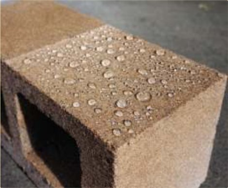 Water beading off a sealed, densified concrete block.