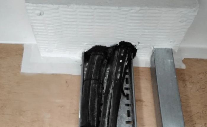 Re-enterable mineral-wool seal around cable penetrations.