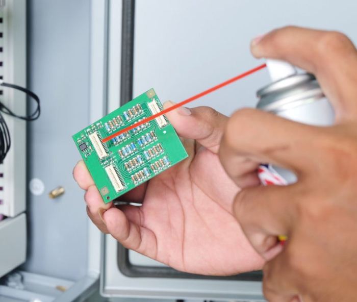 Spraying a circuit board clean in an occupied room.