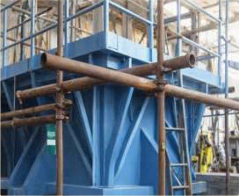 Acid-plant structural steel under a glass-flake novolac armour.