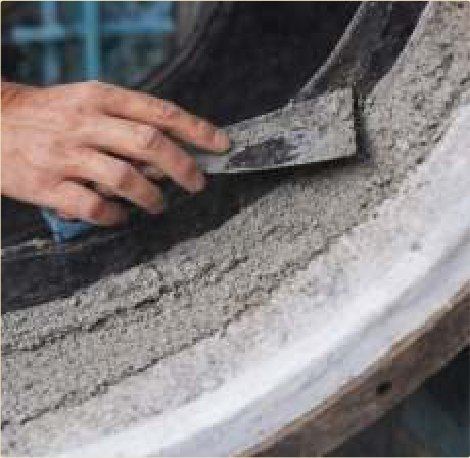 Anti-wear ceramic troweled onto an eroded casing — flow restored.