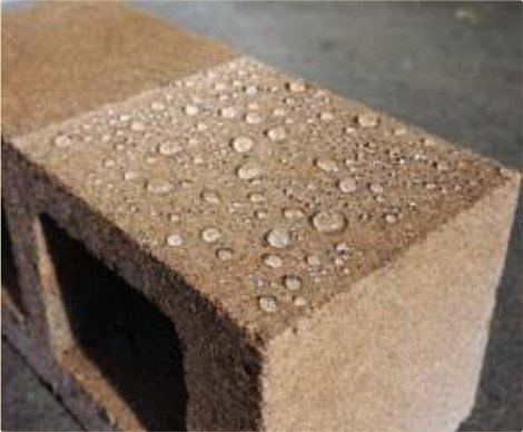 Water beading off a sealed, densified concrete block.