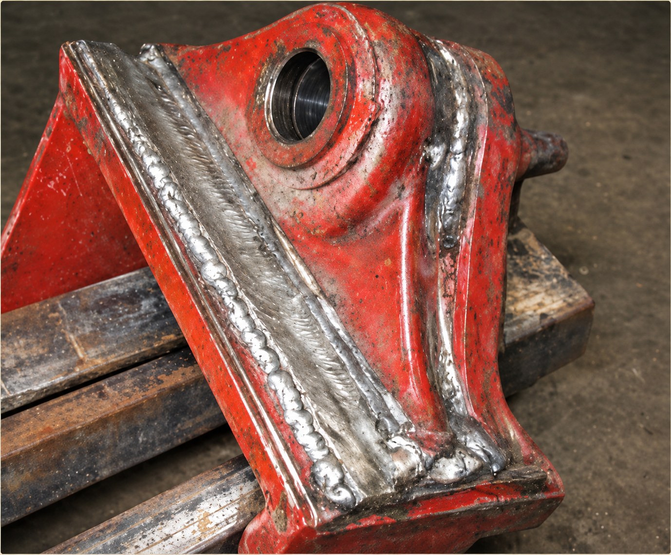 A heavy MS casting repaired — defect-free, on rusty, dirty steel.